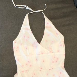 White dress with embroidered light pink flowers.